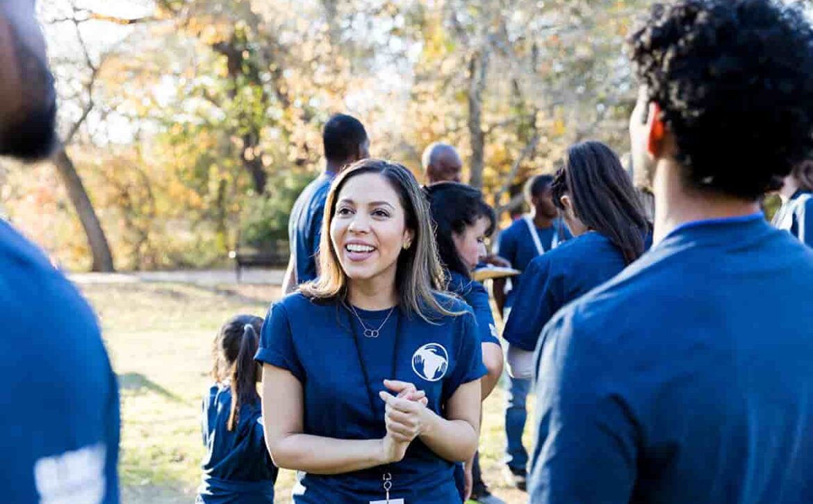 Confident female volunteer talks with friends